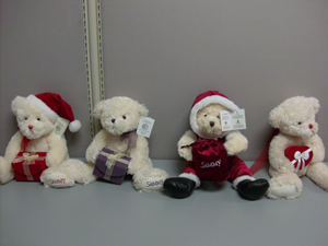 Teddy bears dressed like Santa and holding hearts
